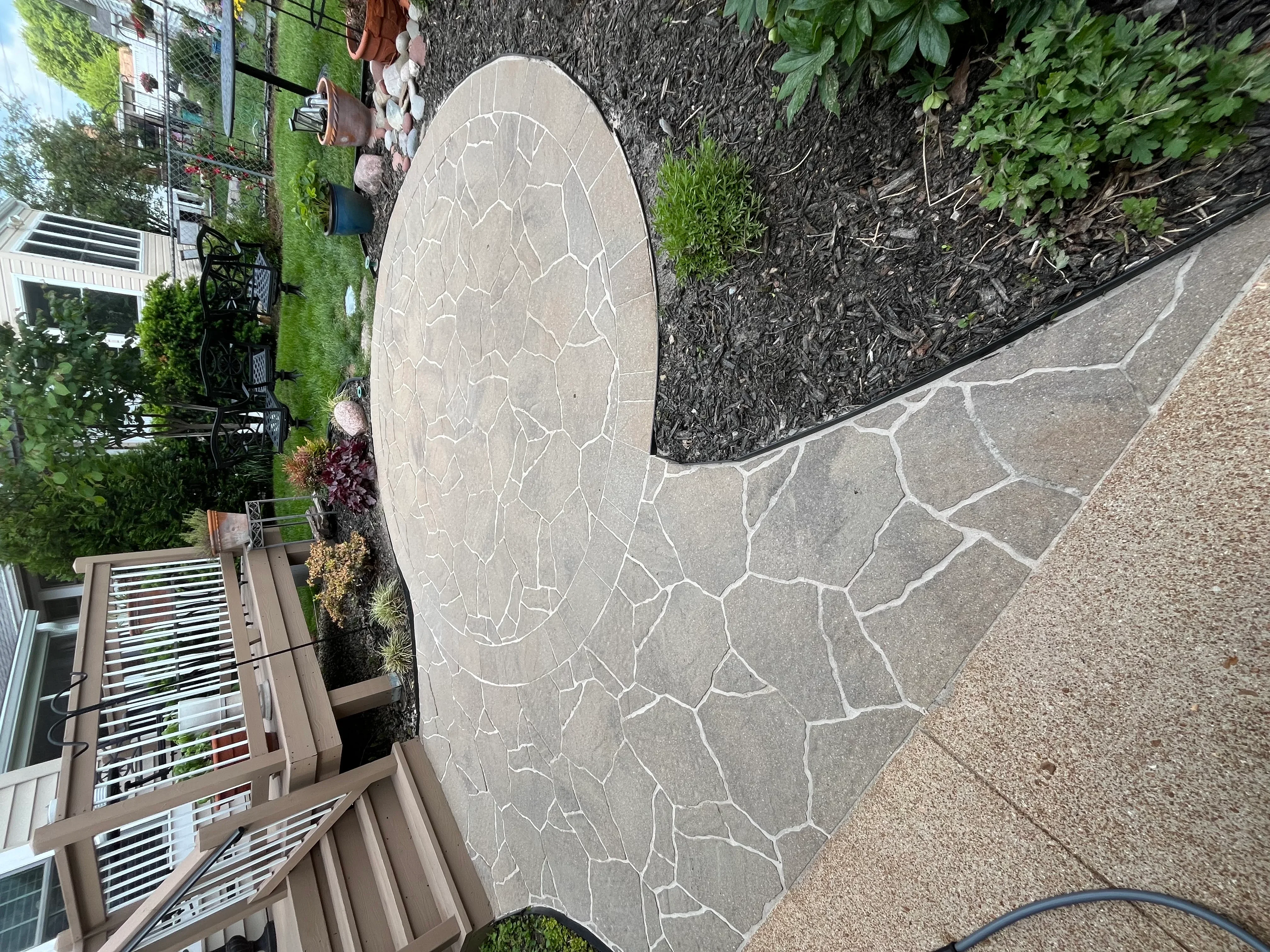 Clean decorative patio stones with geometric pattern design in residential backyard