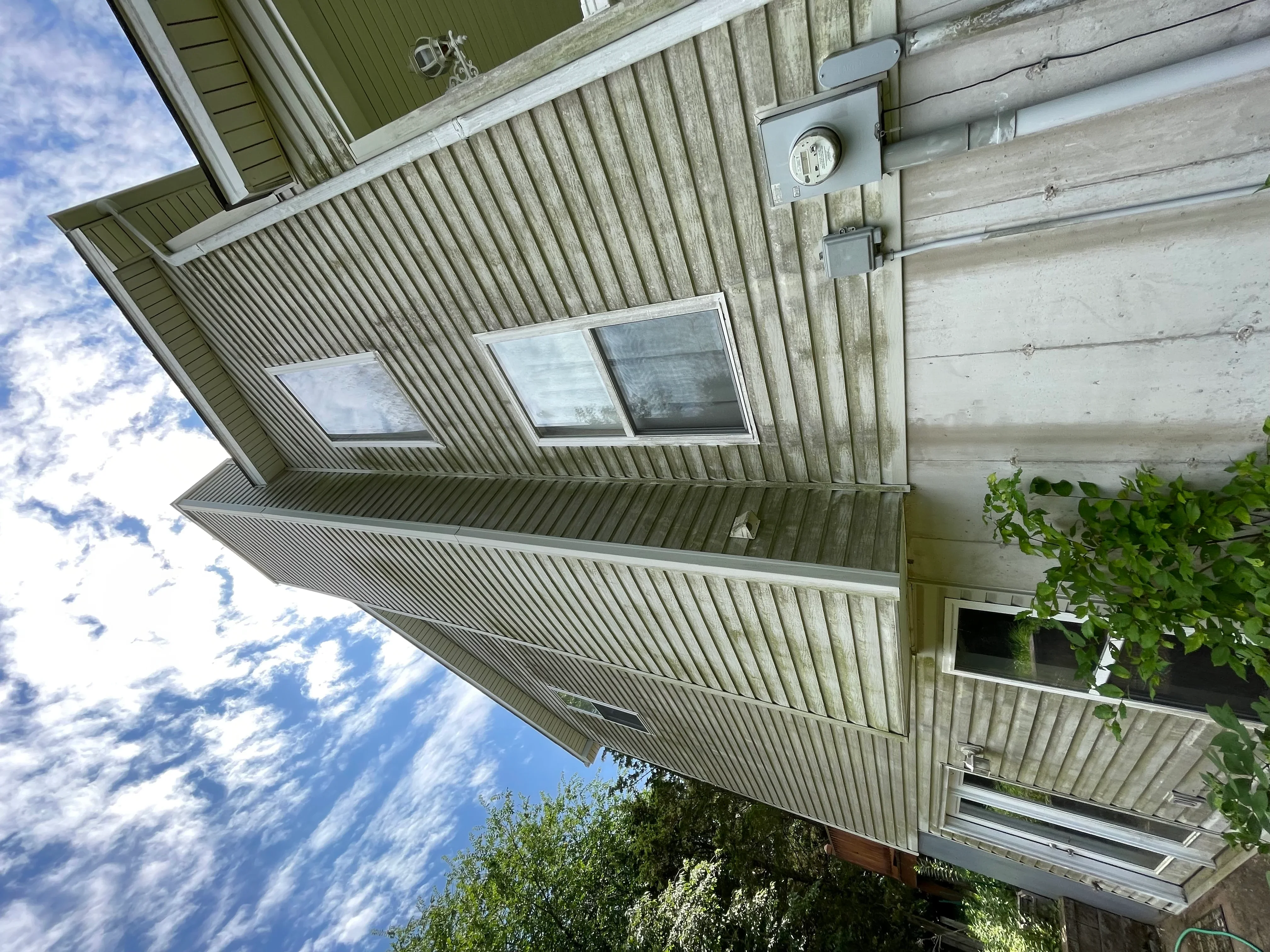 Clean residential soffit and siding after professional soft wash cleaning service