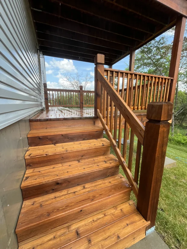 Wooden deck with stairs and railings after pressure washing and cleaning treatment